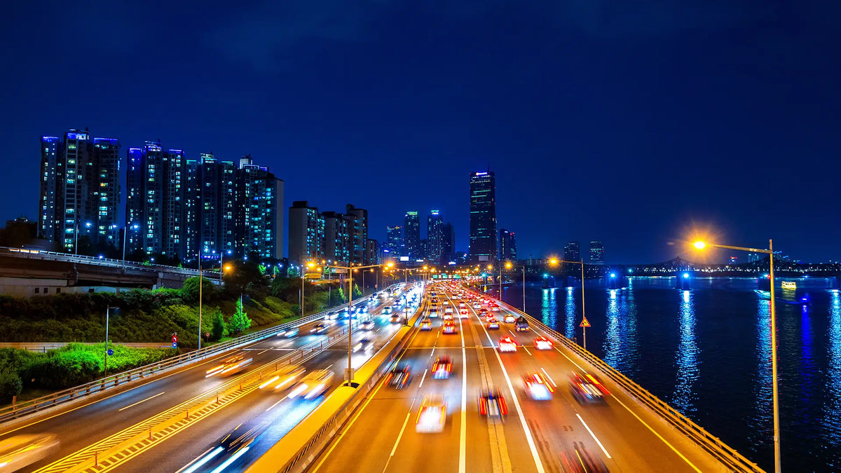Urban highway at night illustrating drone-assisted traffic monitoring, congestion management, and public safety operations.