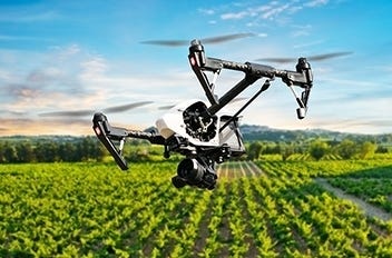 DJI Inspire drone flying over farmland for livestock monitoring, crop analysis, precision agriculture, aerial surveying, field inspections, and data-driven farm management.