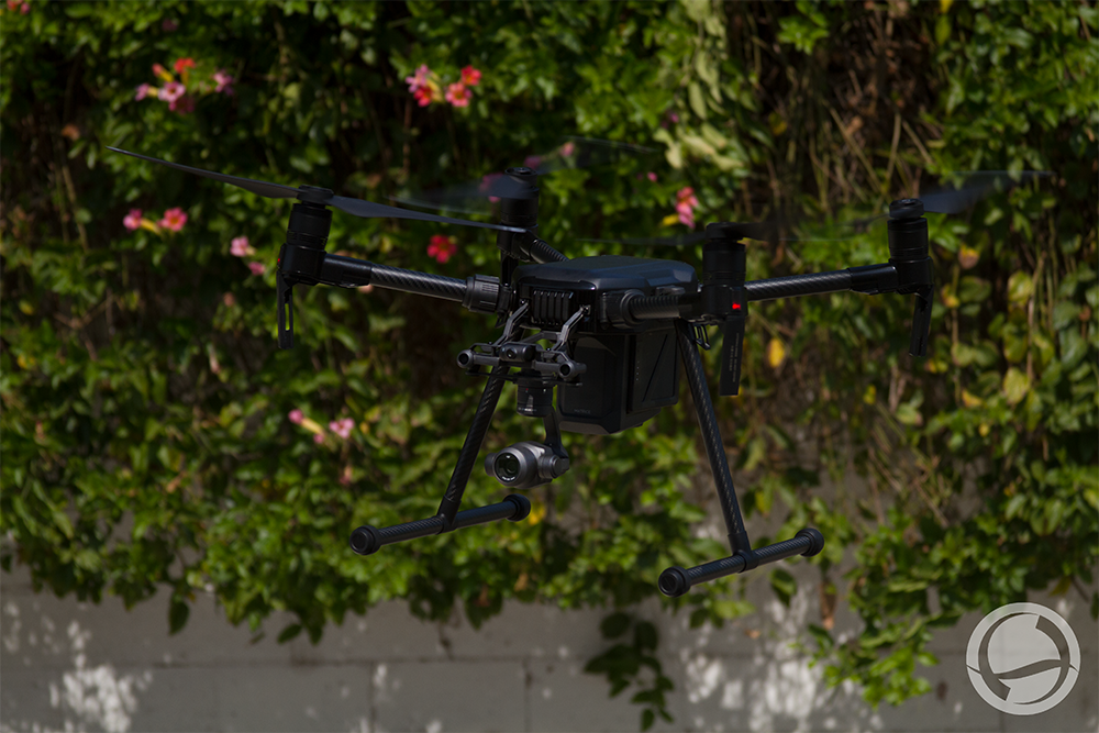 DJI Matrice 200 enterprise drone in flight with a stabilized gimbal camera, showcasing industrial UAV capabilities for inspections, public safety, infrastructure monitoring, mapping, and commercial drone operations.