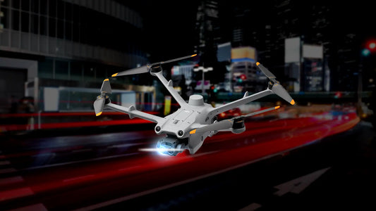 DJI Matrice 4 Series drone equipped with a spotlight flying over a city at night for Drone as a First Responder (DFR) 2.0 public safety operations.