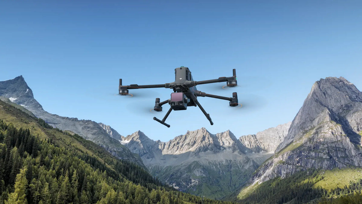 Quadcopter drone performing mountain mapping and terrain inspection flight