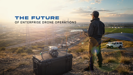 Drone pilot standing beside enterprise drone overlooking multiple industries.