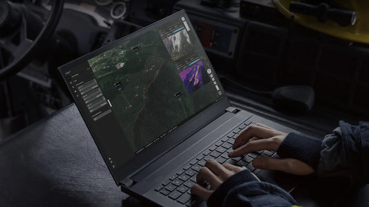 Operator using drone flight planning software to create automated survey missions, manage flight paths, review mapping data, and monitor operations.