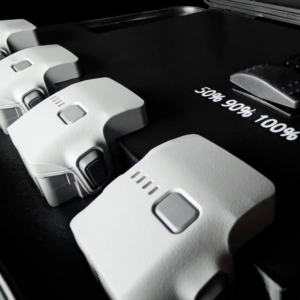 Close-up of Matrice 4 batteries seated in the PRCS charging case