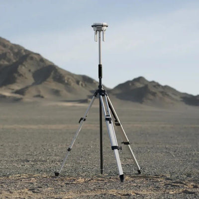 DJI D-RTK 3 survey pole and tripod deployed at an outdoor survey site