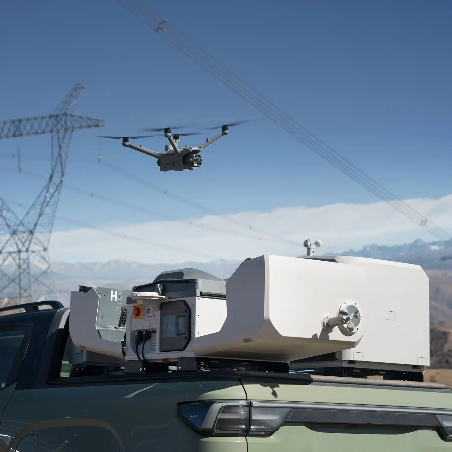 Matrice 4TD with DJI Dock 3 at the bed of a pickup truck, with powerlines in the background.