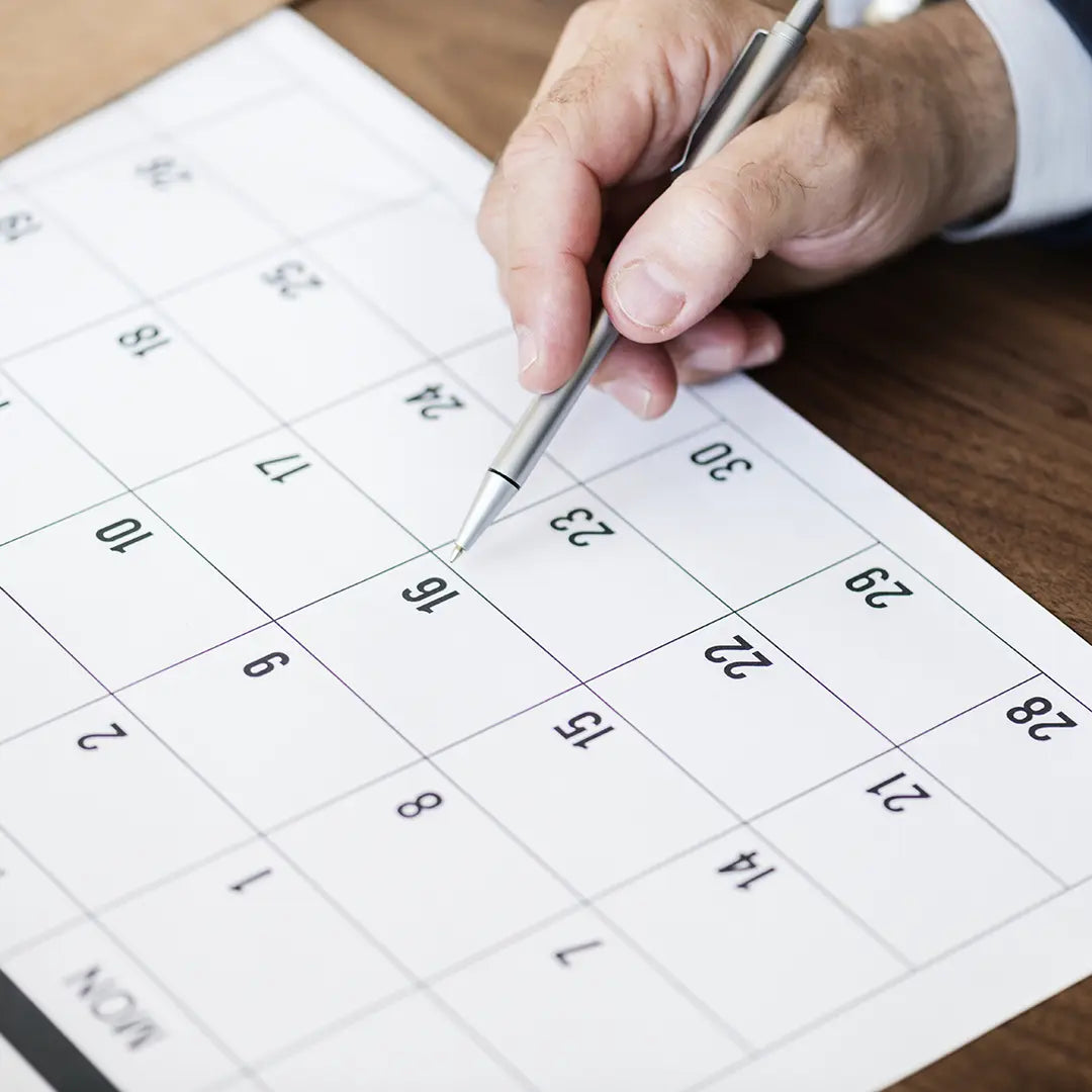 Man marking due date on calendar for Net30 payments.