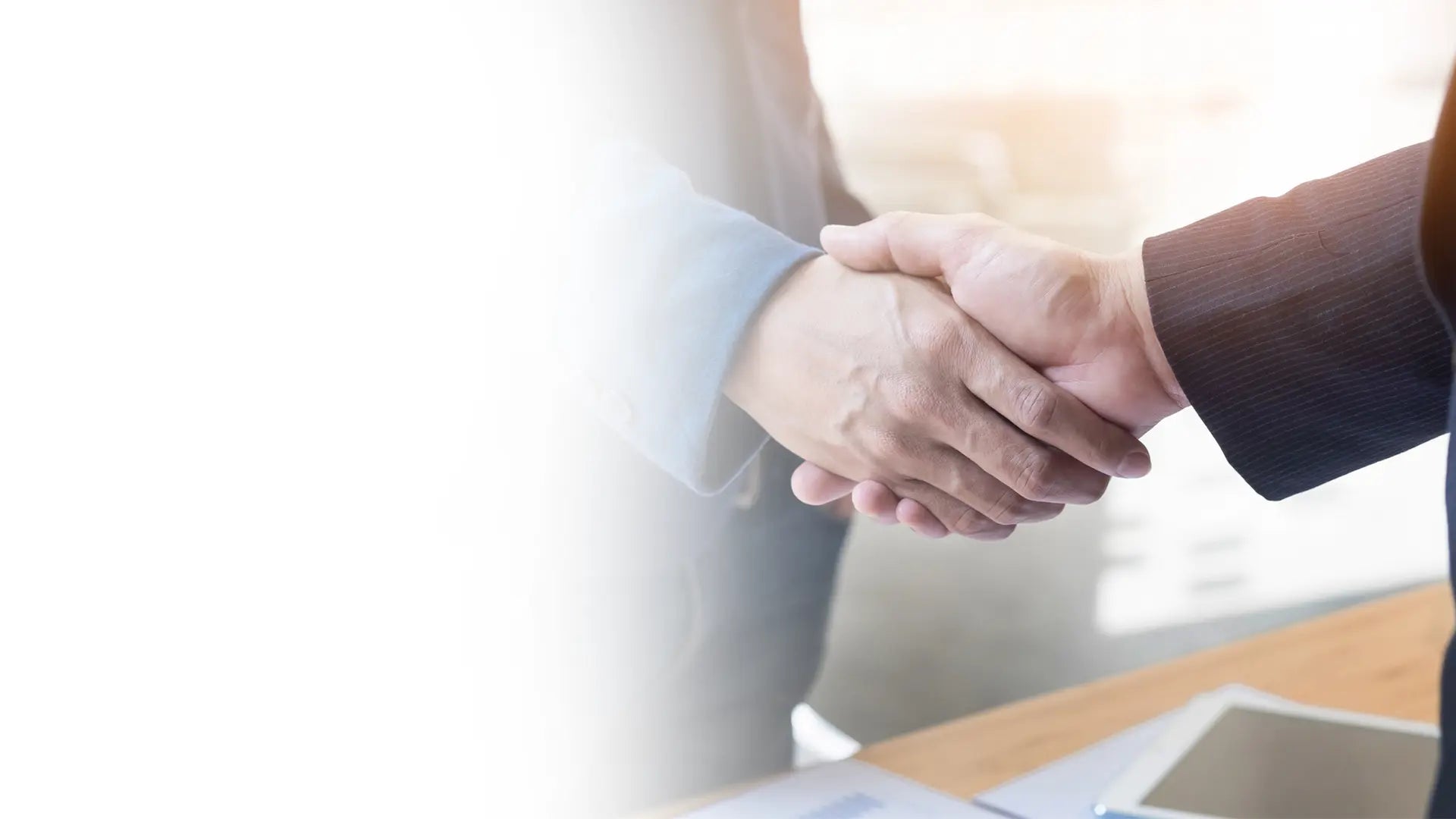Two men shaking hands signifying DSLRPros partnership.