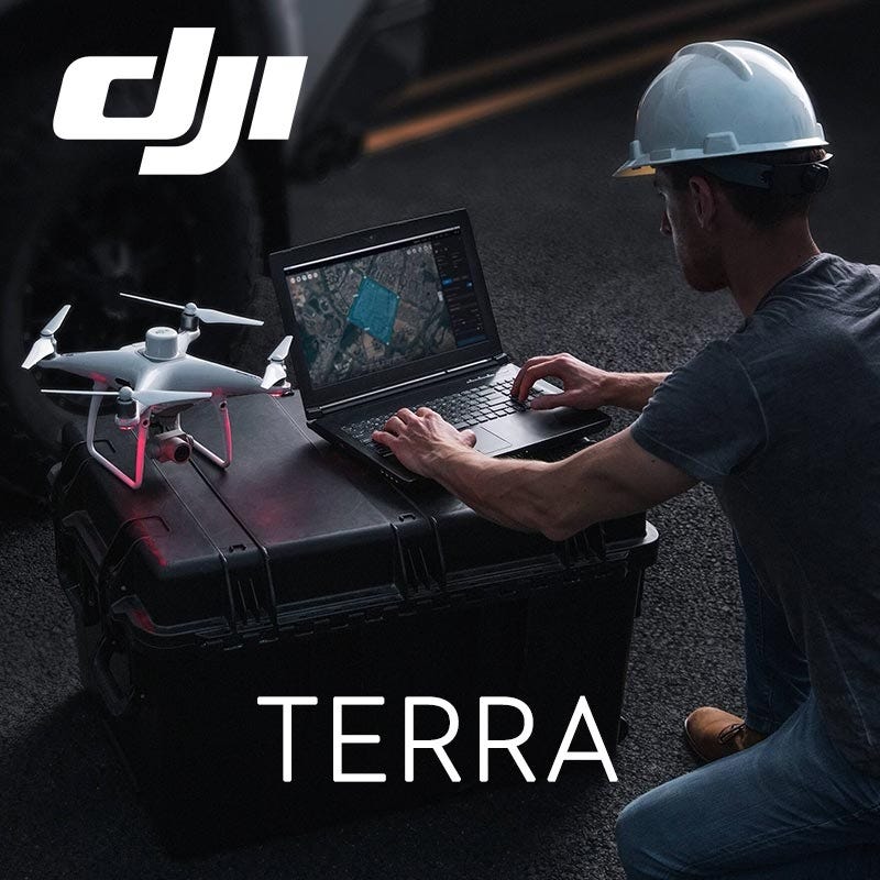 Technician using DJI Terra on a laptop beside a survey drone